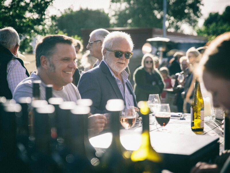 People standing at a bar enjoying an event