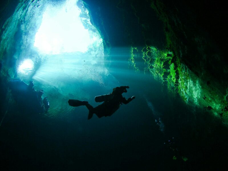 Image of a diver taken from the depths of Kilsby Sinkhole, looking towards the surface.