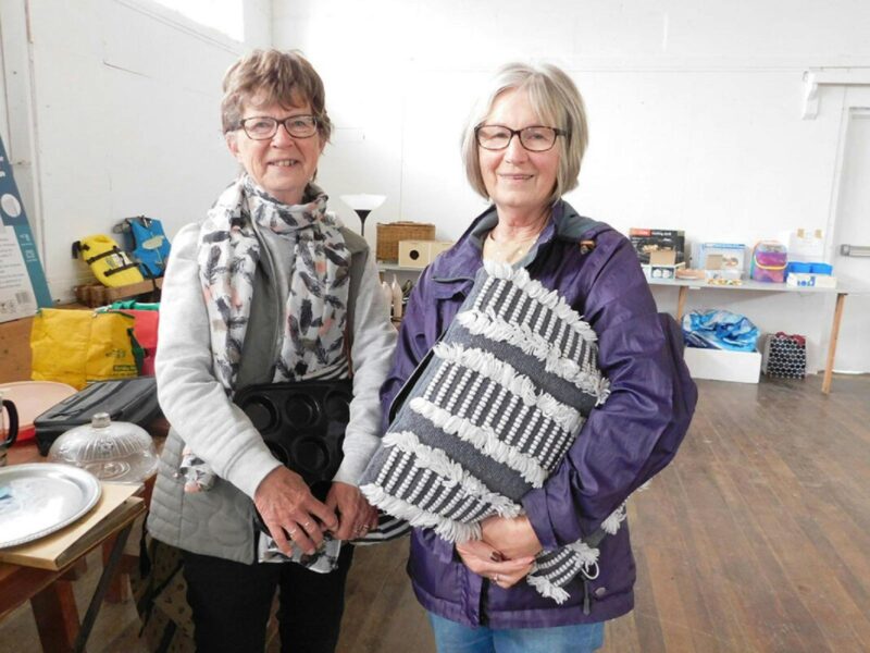 Two ladies holding craftwork