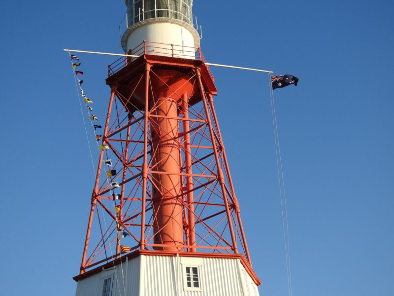 Cape Jaffa Lighthouse with signal flags and Australian flag flying.