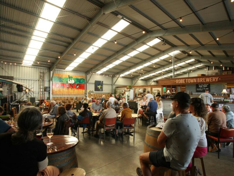 ATDW Robe Town Brewery.jpeg View of the Robe Town Brewery cellar door with people sitting at the tables