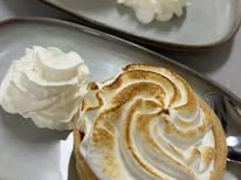ATDW Mothers Day At The Tiger Hotel.jpeg A lovely yummy looking round tart with a meringue top accompanied by a swirl of cream.