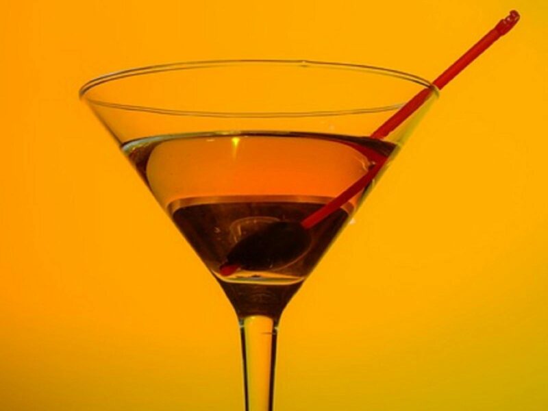 ATDW-Cocktail-Night-Millicent.jpeg Cocktail glass with an amber coloured drink half full with a red straw in it.