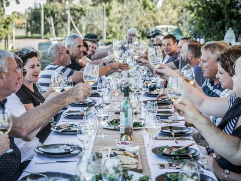 ATDW Raidis Estate First Friday Winemakers Lunch September.jpeg 12 people around a table eating food and drinking wine