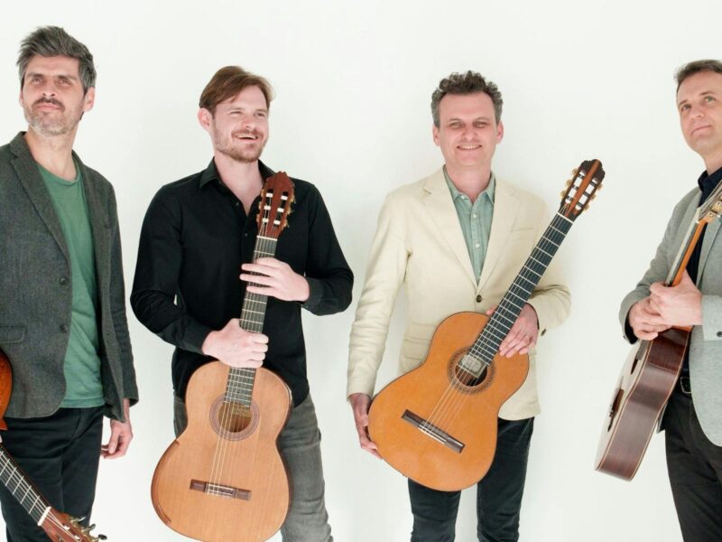 the quartet all holding guitars