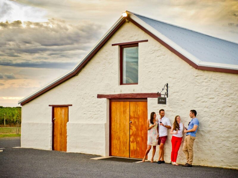 Adults enjoying glass of wine outside Katnook Estate Stables