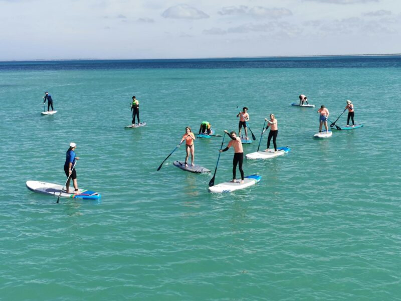 International exchange students experience SUP for the first time, at Southend Jetty