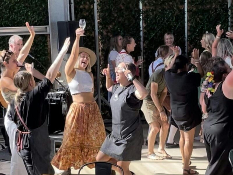 people dancing to music whilst enjoying a glass of wine