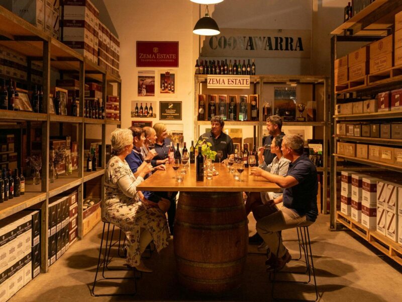 people sit around table in musuem area