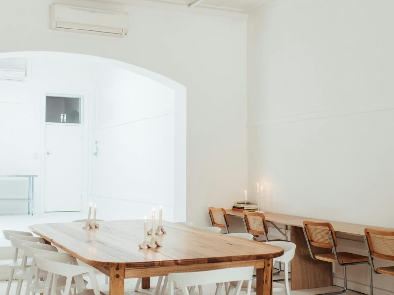 Light filled commercial space, with a large wooden table in the centre.