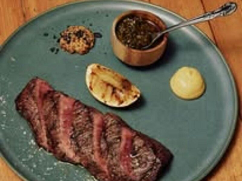 A medium cooked Mayura Station Wagyu steak on a green plate. Looks yummy.