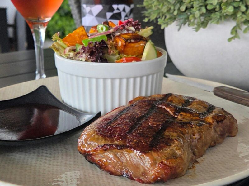 Grilled Scotch fillet steak with roasted sweet potato and green bean salad, served on the deck