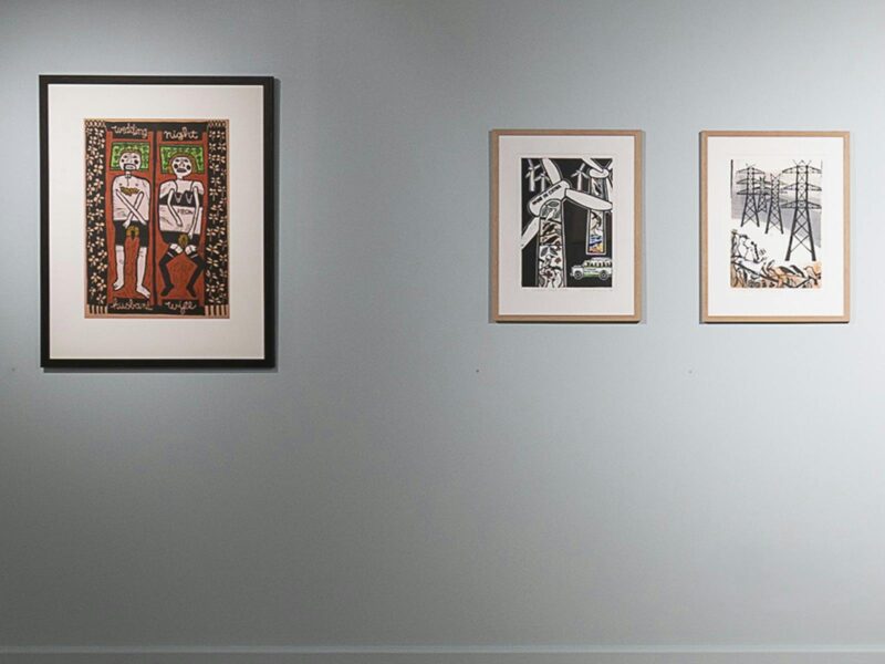 printmaking artworks on a pale green wall