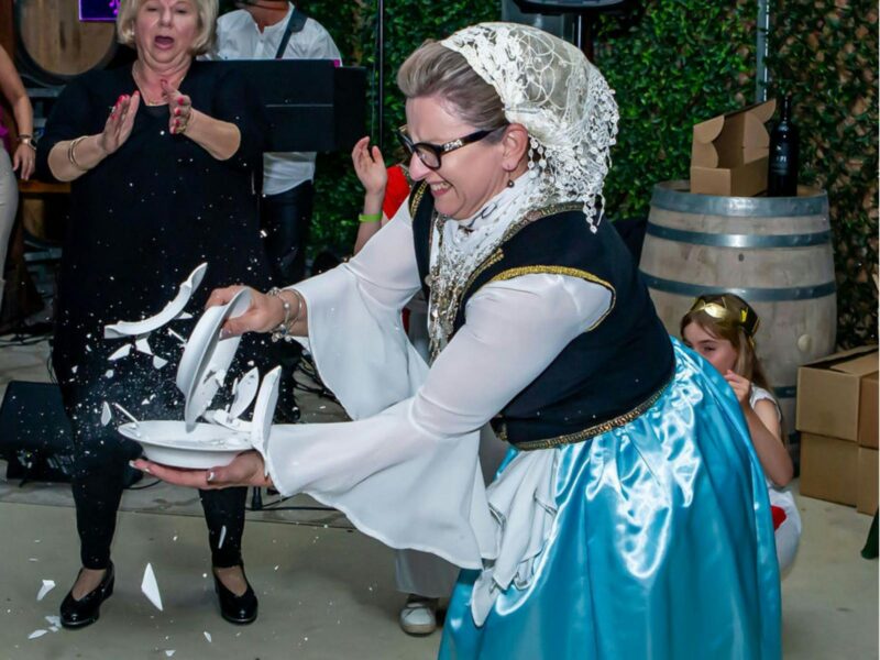 Traditional lady smashing plates